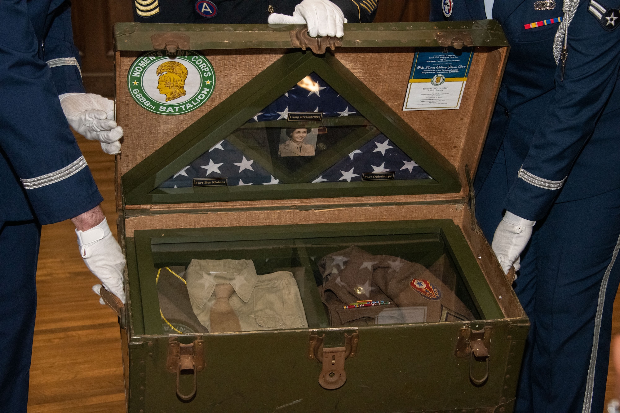 Mrs.
Davis’s shadowbox is housed in an authentic World War II trunk. This trunk holds a uniform
pieced together by Americans across the country after hearing Mrs. Davis’s story. Complete
with a replica of Mrs. Davis’s medals and an original World War II Women’s Army Corps Patch.
The flags encased were flown at each base Mrs. Davis served, including Fort Oglethorp, GA,
Camp Breckinridge, KY, and Fort Des Moines, IA.