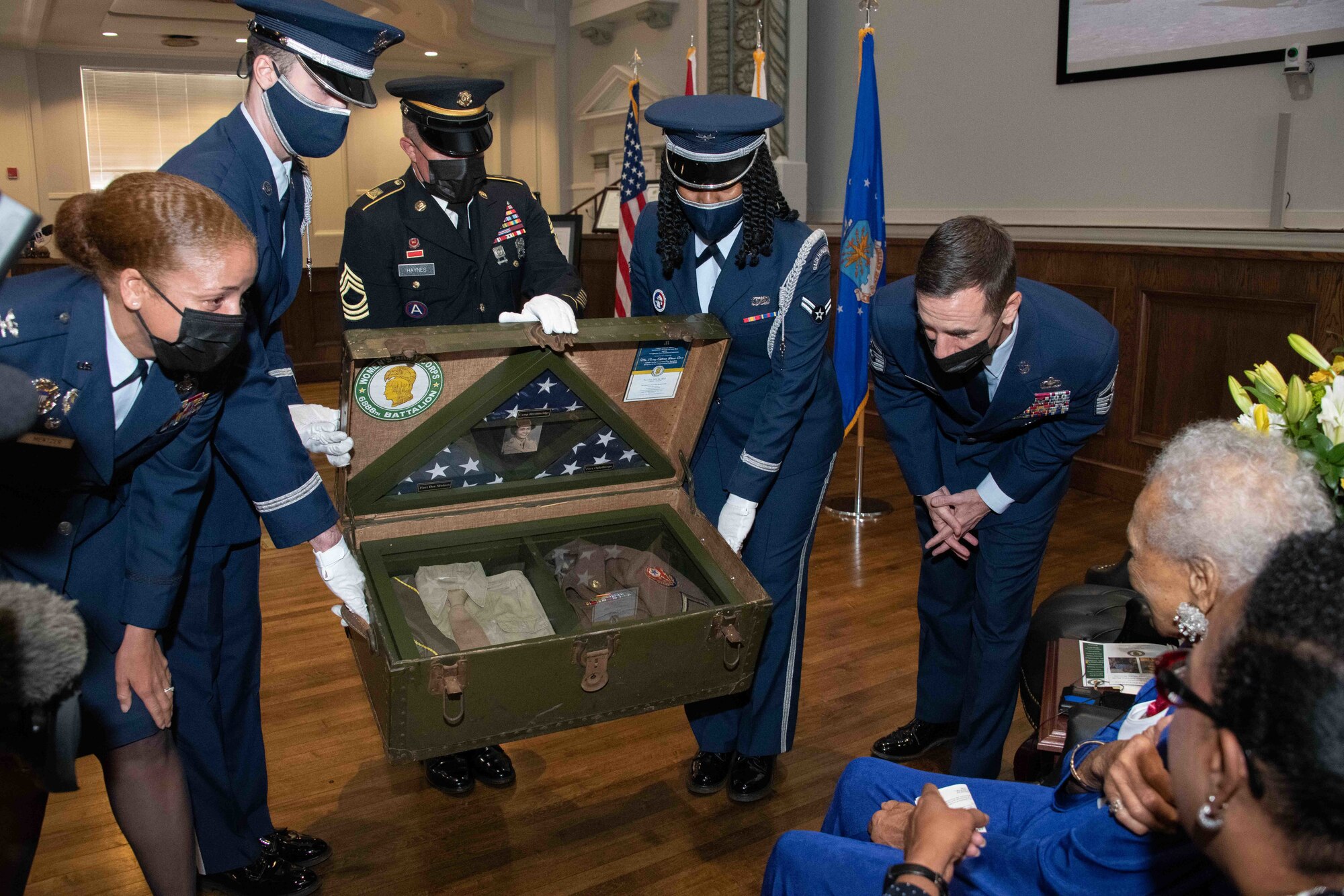 Mrs. Davis’s shadowbox is housed in an authentic World War II trunk. This trunk holds a uniform pieced together by Americans across the country after hearing Mrs. Davis’s story. Complete with a replica of Mrs. Davis’s medals and an original World War II Women’s Army Corps Patch. The flags encased were flown at each base Mrs. Davis served, including Fort Oglethorp, GA, Camp Breckinridge, KY, and Fort Des Moines, IA.