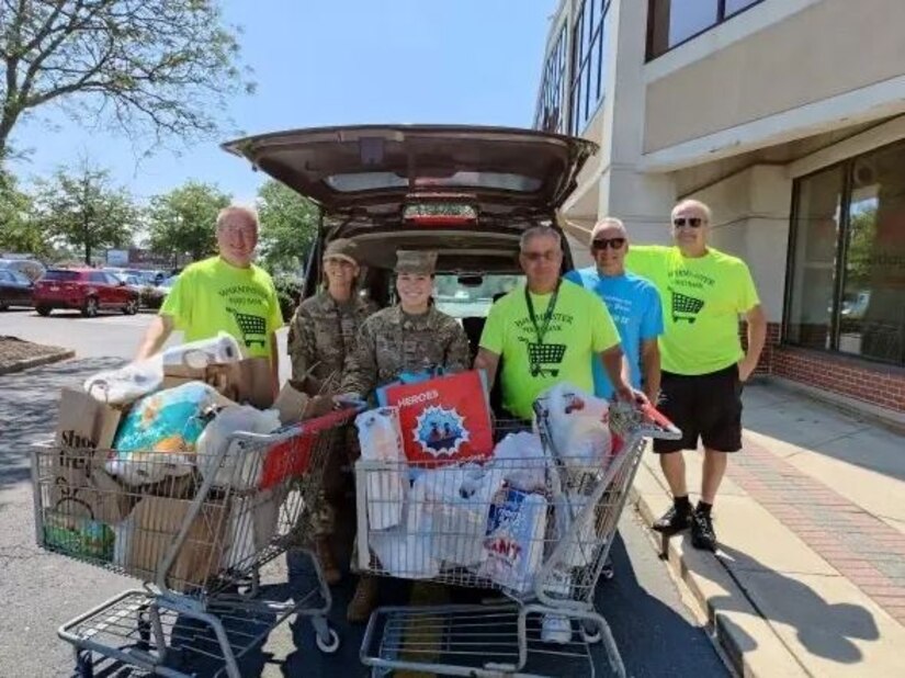 Pennsylvania Air National Guard Master Sgt. Rachel M. Ali (center left) and Tech. Sgt. Shawna Belusko (center right), both Production Recruiters with the 111th Attack Wing based at Biddle Air National Guard Base in Horsham, Pennsylvania stand with members and volunteers of the Warminster Food Bank during a food drive at a local supermarket in Warminster, Pennsylvania. The event, dubbed “Stuff the Humvee,” helped the food bank gather more than 2000 pounds of non-perishable food items to support families in need in the surrounding communities. (Courtesy photo from Warminster Food Bank)