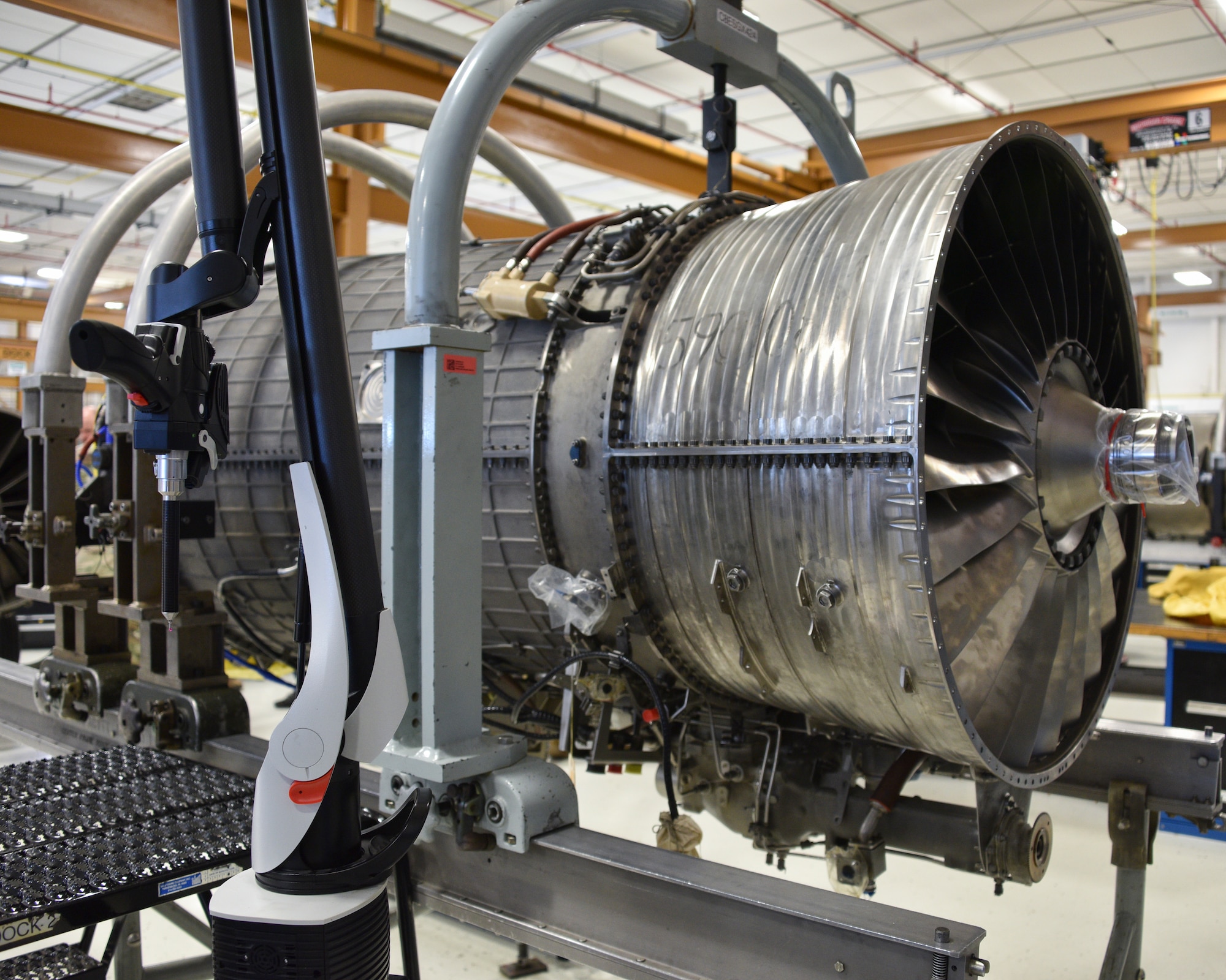 Photo of an aircraft engineer taking measurements of an aircraft engine