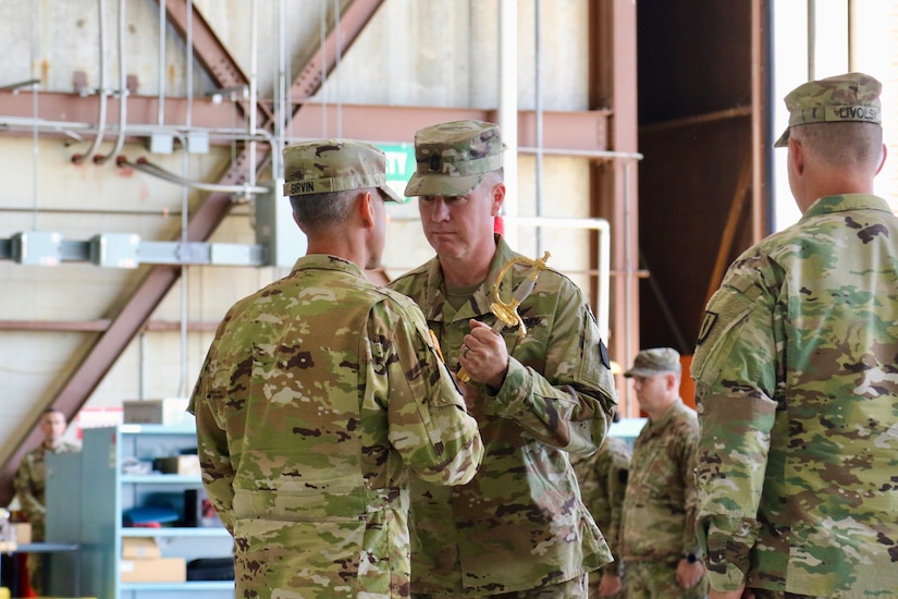 U.S. Soldiers with the 28th Expeditionary Combat Aviation Brigade, family and friends gather for a change of responsibility ceremony at Muir Army Airfield. During the ceremony, Command Sgt. Maj. Sean Livolsi passed the brigade’s senior enlisted leader responsibilities to Command Sgt. Maj. Jeff Huttle.