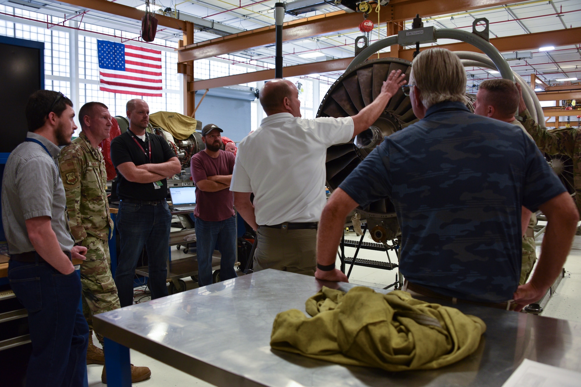 Photo of an aircraft engineer taking measurements of an aircraft engine