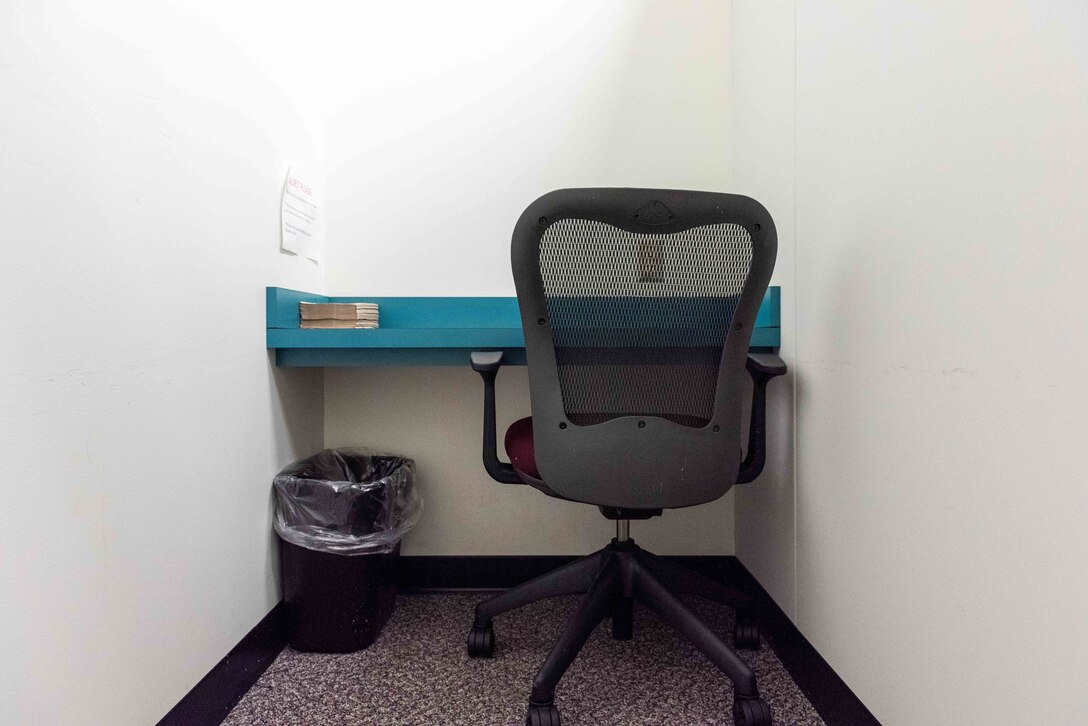 A room with a chair and a desk.