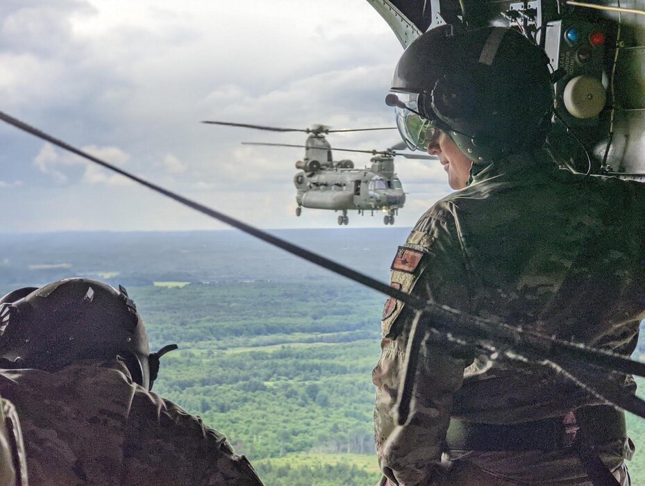 Photo of airmen assigned to the Vermont National Guard’s 158th Fighter Wing ride in a CH-47 Chinook assigned to 27 Squadron, RAF Odiham, U.K, en route to support the NATO Air Shielding mission alongside French, British, Estonian, and Belgium allies at Amari Air Base, Estonia, July 6, 2022.