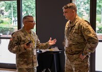 Joint Task Force Civil Support commanding general, U.S. Army Maj. Gen. Jeff Van, left, discusses defense support of civil authorities response operations with Col. Larry Dewey, the defense coordination officer assigned to the Federal Emergency Management Agency Region III Defense Coordination Office, at a hotel in Philadelphia, during the Task Force 46 Multi-Domain Operations Dense Urban Terrain Exercise 2022, July 26, 2022.