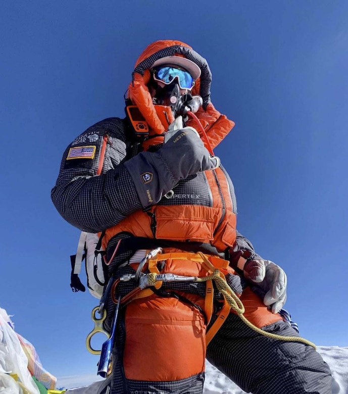 A man dressed in cold weather gear poses for a photo.