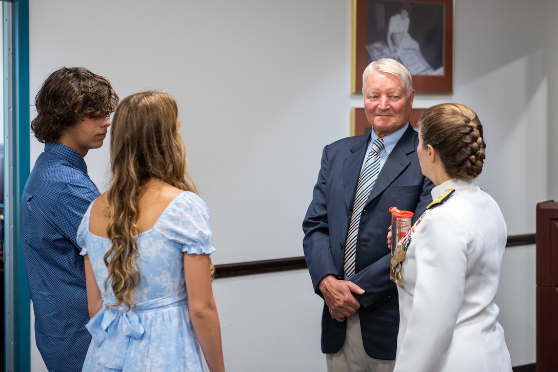 Family and friends of Navy Rear Adm. Kristen Fabry gather for a light breakfast prior to the Defense Logistics Agency Land and Maritime Change of Command and Retirement Ceremony July 22. Fabry is retiring this month after 31 years of service in the Navy.