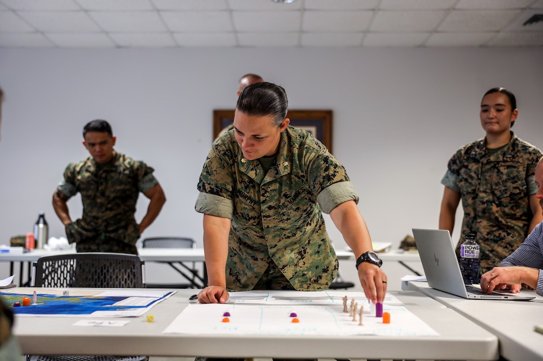 U.S. Marine Corps Maj. Sarah Murphy, a MAGTF planner assigned to 2nd Marine Logistics Group, participates in the Basic Analytic Wargaming Course on Marine Corps Base Camp Lejeune, N.C., July 22, 2022. The BAWC is a 5-day course that provides students a hands-on experience with designing, developing, executing, and analyzing wargames. Wargames are a form of strategy game and essential to applying Marine Corps concepts of the 21st century, replicating or creating military scenarios that assists military personnel to train the mind in the art of strategic thinking.