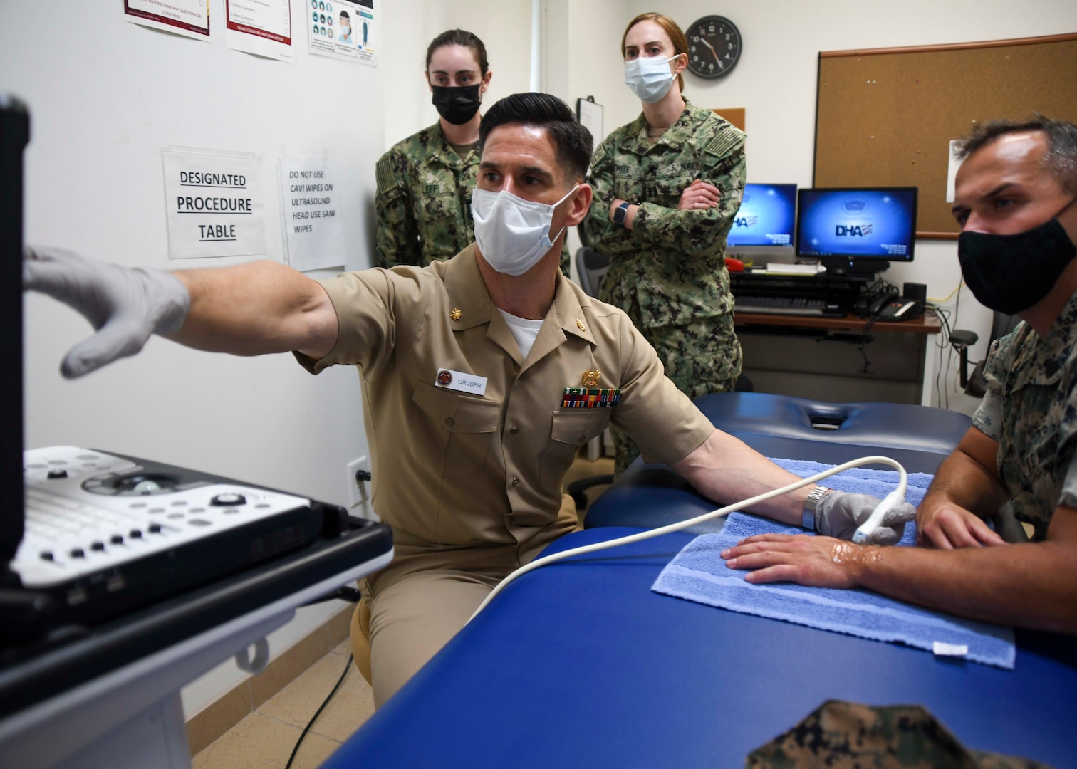 Lt. Cmdr. Jonathan Gruber, department head for sports medicine, performs an ultrasound at the SMART Clinic located at Wallace Creek Fitness Center aboard Marine Corps Base Camp Lejeune. Camp Lejeune Family Medicine Residency Program residents observe the appointment.