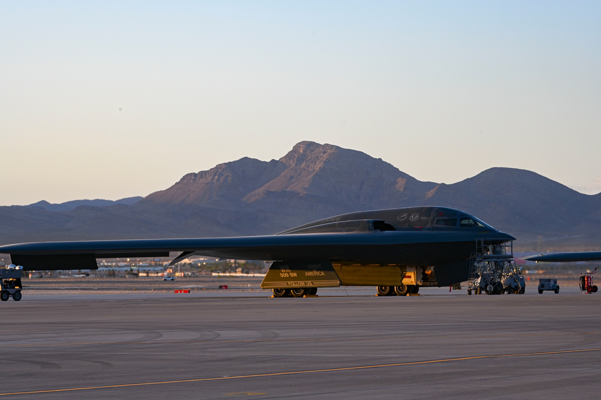 U.S. Air Force B-2 Spirit stealth bomber aircraft from 509th Bomb Wing, Whiteman Air Force Base, Missouri, sits on the flight line at Nellis Air Force Base, Nevada, June 6, 2022. The Weapons School in Las Vegas, Nevada trains tactical experts and leaders to control and exploit air, space and cyberspace on behalf of the joint force. Every six months, approximately 130 weapons officers and enlisted specialists graduate as tactical system experts, weapons instructors and leaders of Airmen. (U.S. Air Force photo by Staff Sgt. Alexandria Lee)