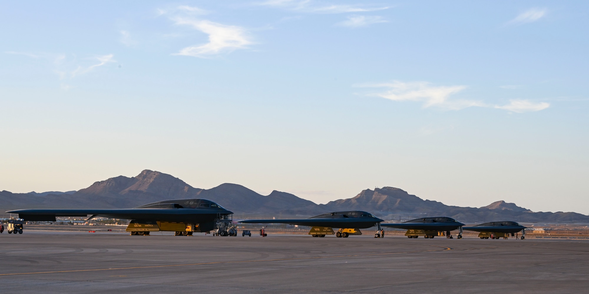 Four U.S. Air Force B-2 Spirit stealth bomber from 509th Bomb Wing, Whiteman Air Force Base, Missouri, sit on the flight line at Nellis Air Force Base, Nevada, June 6, 2022. The 325th Weapons School in Las Vegas, Nevada trains tactical experts and leaders to control and exploit air, space and cyberspace on behalf of the joint force. Every six months, approximately 130 weapons officers and enlisted specialists graduate as tactical system experts, weapons instructors and leaders of Airmen. (U.S. Air Force photo by Staff Sgt. Alexandria Lee)