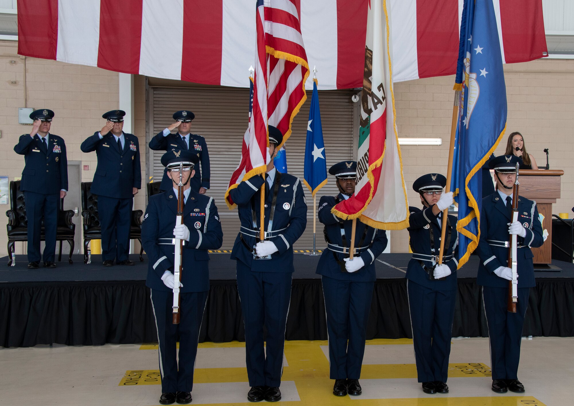 The Travis Elite Honor Guard post the colors during the 60th Air Mobility Wing change of command ceremony at Travis Air Force Base, California, July 27, 2022. A change of command ceremony is a military tradition of formal transfer of command, responsibilities and authority from one commander to another. (U.S. Air Force photo by Heide Couch)