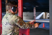 U.S. Air Force Senior Airman Edward Jennings, 628th Security Forces Raven team member, performs a function check during the Excellence in Competition Pistol Shoot