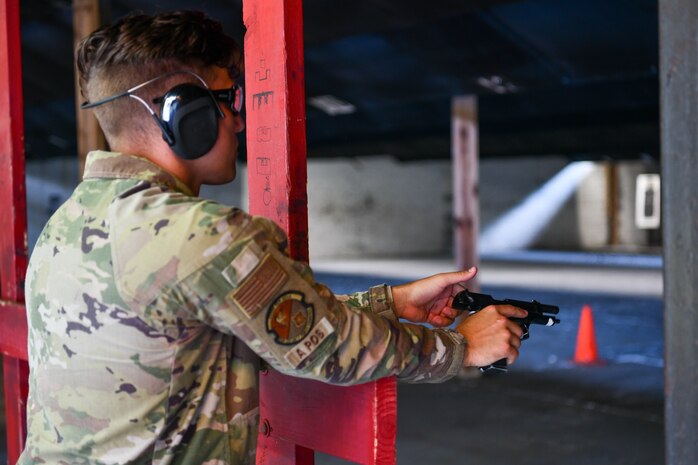 U.S. Air Force Senior Airman Edward Jennings, 628th Security Forces Raven team member, performs a function check during the Excellence in Competition Pistol Shoot