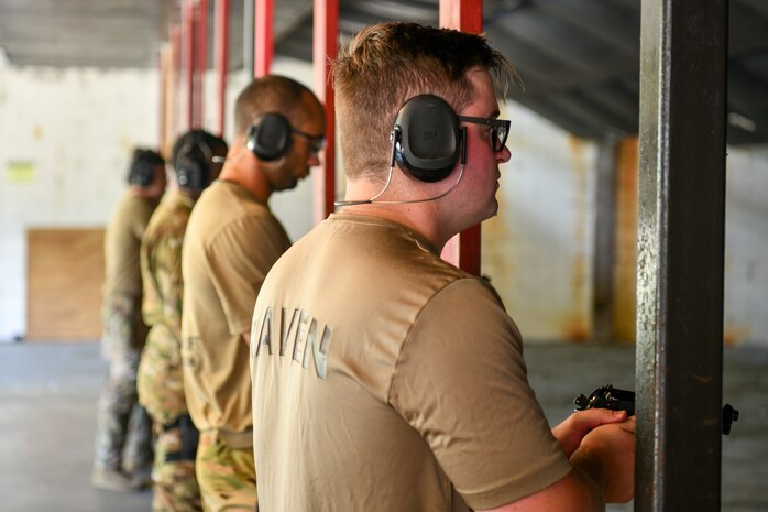 U.S. Airmen from the 628th Security Forces squadron prepare to fire during the Excellence in Competition Pistol Shoot