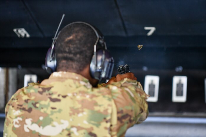 U.S. Airmen from the 628th Security Forces squadron prepare to fire during the Excellence in Competition Pistol Shoot