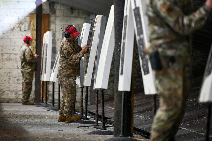 U.S. Air Force Combat Arms Training and Maintenance instructors record the scores of participants in the Excellence in Competition Pistol Shoot