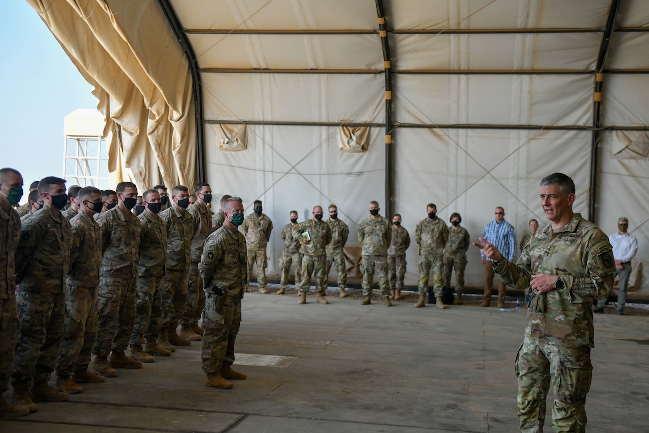 A military officer speaks to troops.