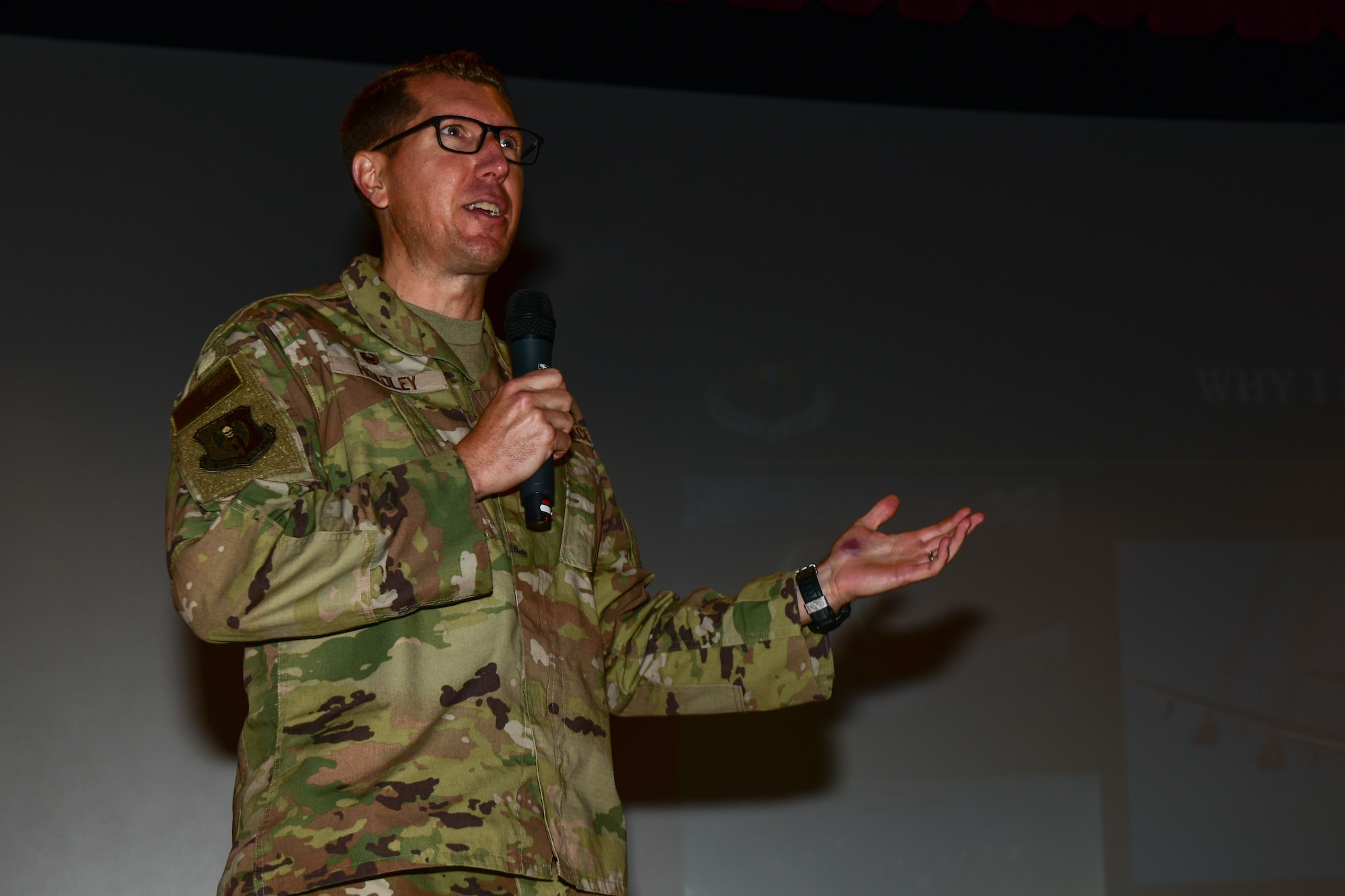 Col. Daniel Hoadley, 5th Bomb Wing Commander, speaks at an all call at the base theater on Minot Air Force Base, North Dakota, July 25, 2022. Hoadley stated that mutual respect and team work are important to building a positive work environment. (U.S. Air Force photo by Airman Alysa Knott)