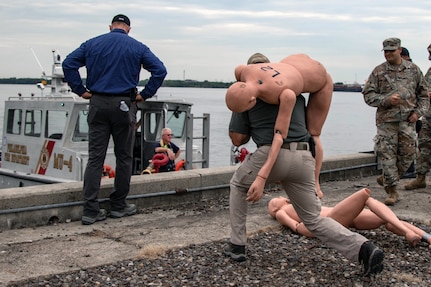 Philadelphia firefighters, along with U.S. Army North personnel and Task Force 46 Soldiers, deliver a notional victim to mass casualty decontamination personnel.