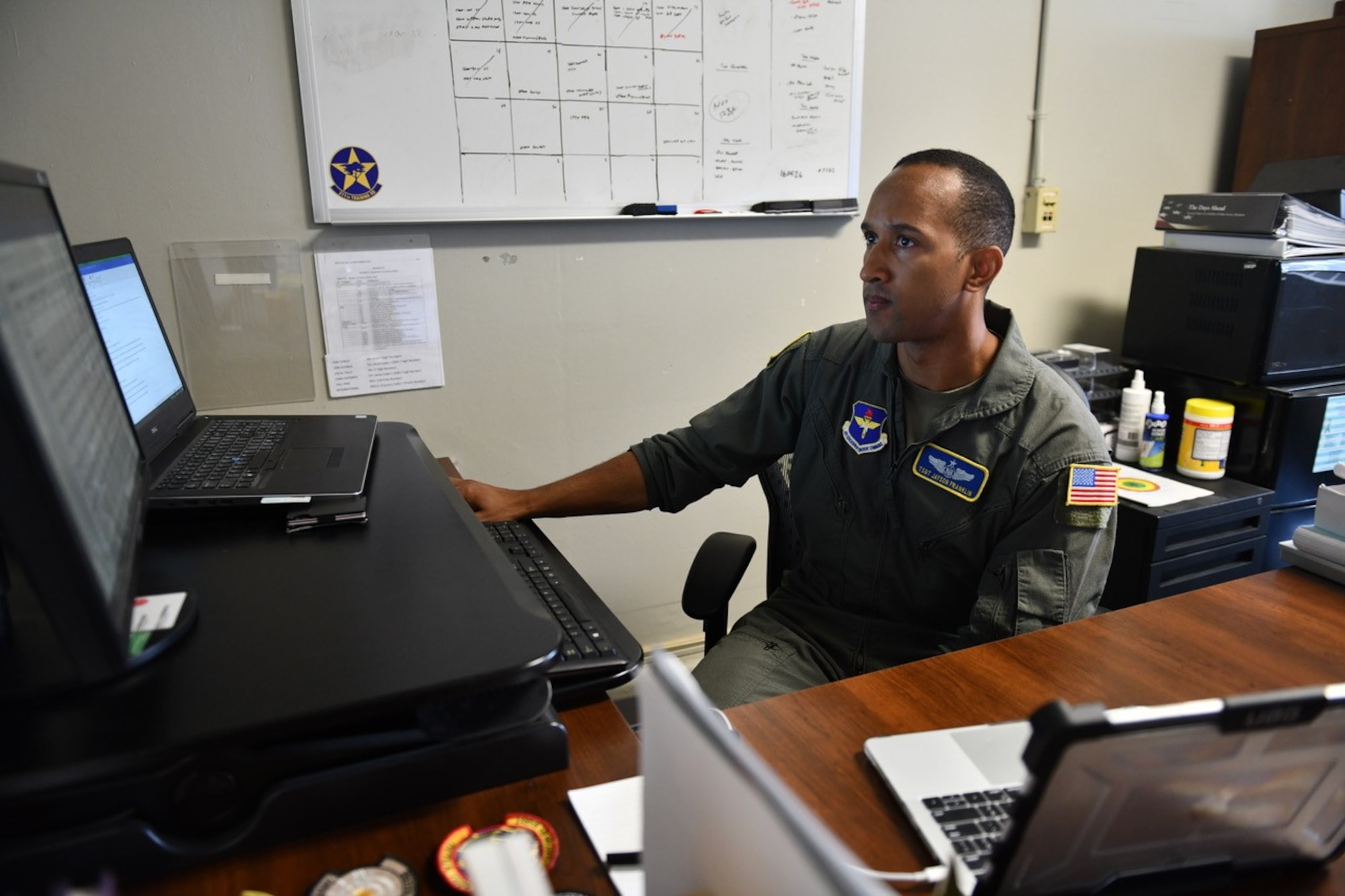 U.S. Air Force Tech. Sgt. Jayson Franklin, 311th Training Squadron Arabic academic training advisor, works at his desk in his squadron building at Presidio of Monterey, Calif., July 20, 2022. In addition to his advisor duties, Franklin hosts study halls, tutors students, and manages the unit fitness program. (U.S. Air Force photo by Leonardo Carrillo)