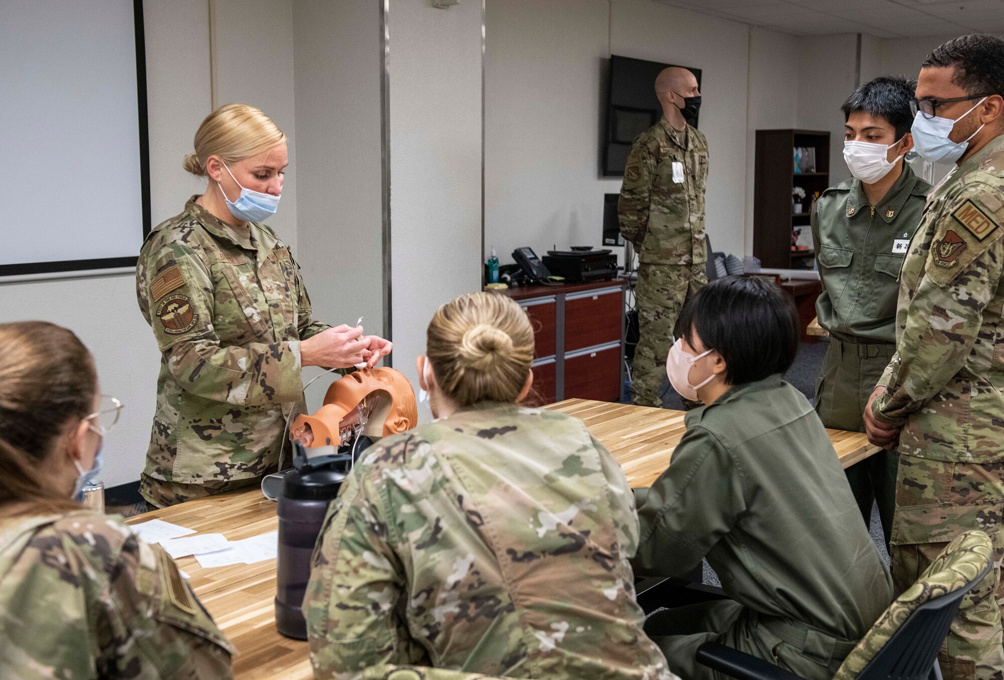 A U.S. Air Force Airman explains medical procedures to students and Airmen