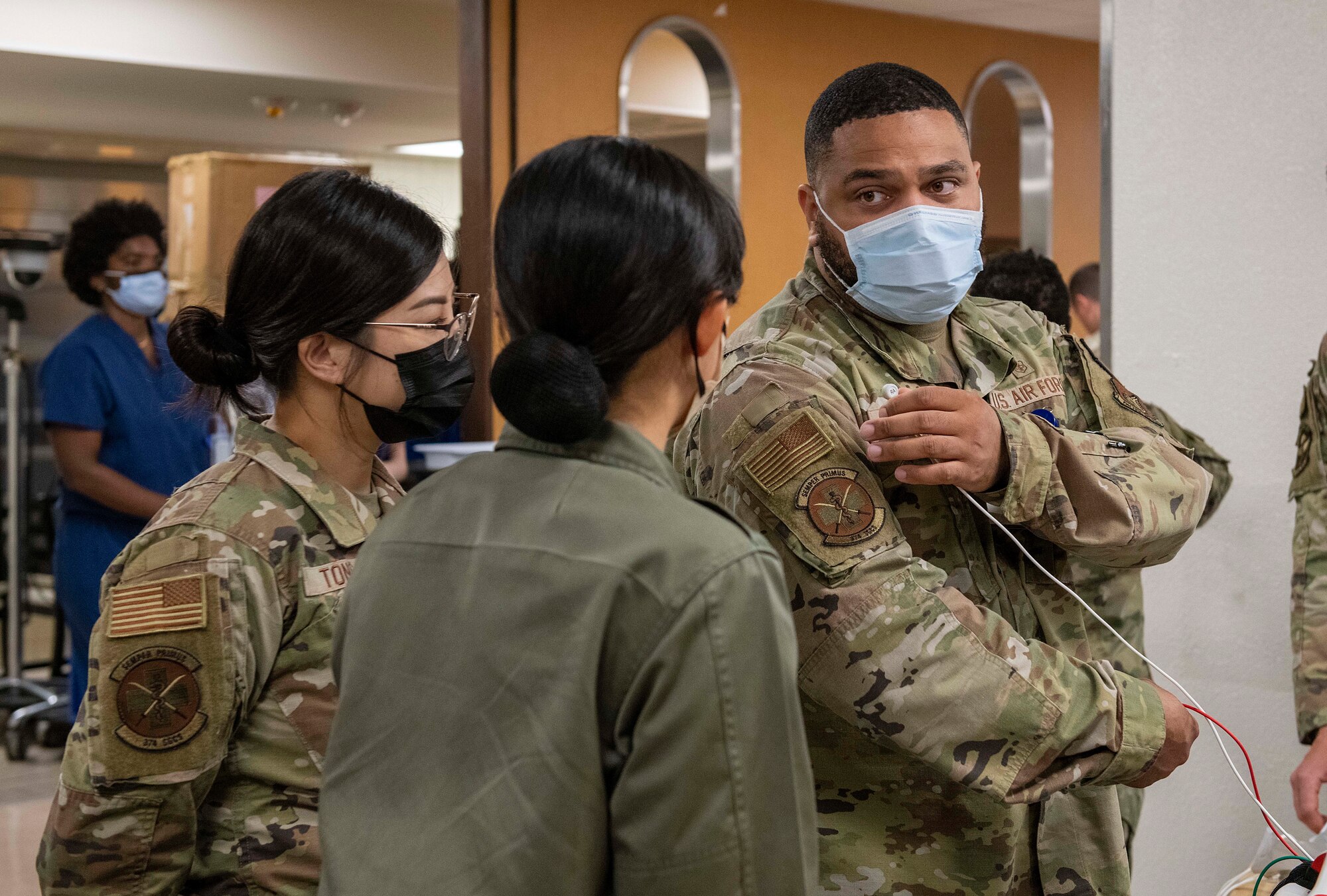 A U.S. Air Force Airman explains medical procedures to students and Airmen