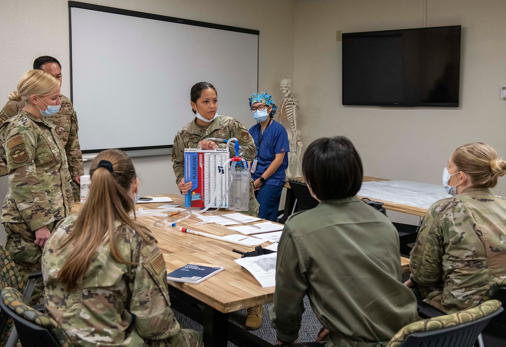 A U.S. Air Force Airman explains medical procedures to students and Airmen