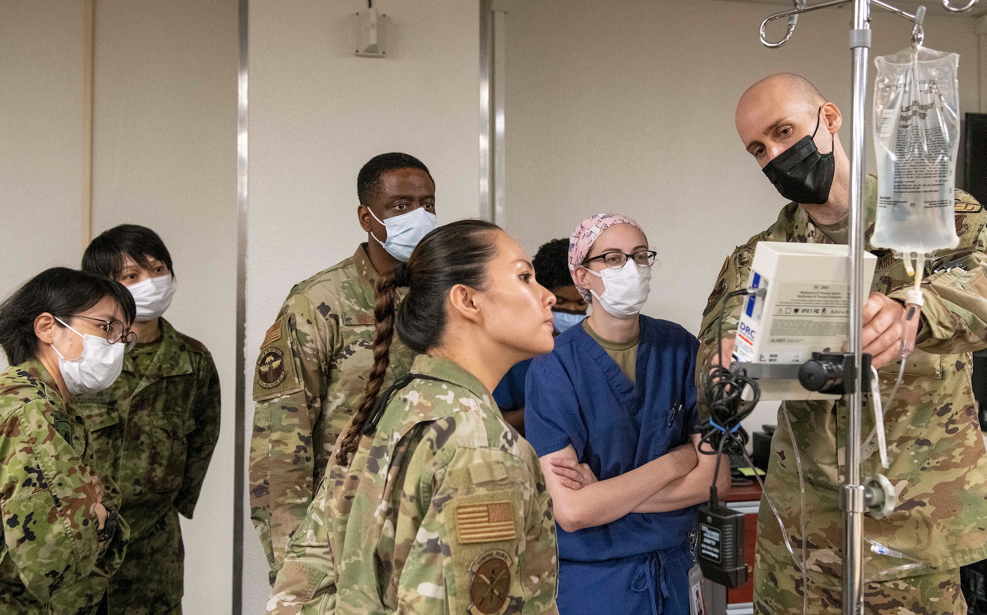 A U.S. Air Force Airman explains medical procedures for students and instructors