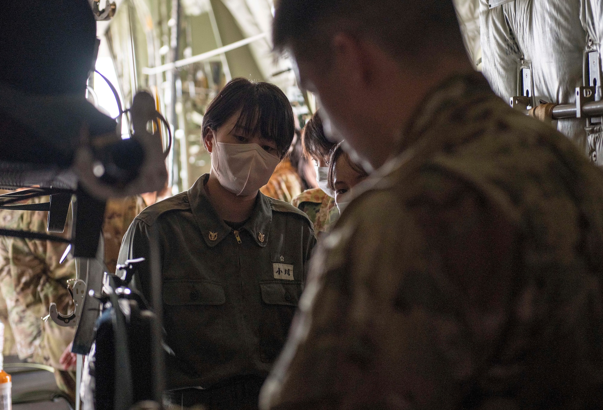 A U.S. Air Force Airman explains simulated patient treatment in a C-130J Super Hercules for students and instructors