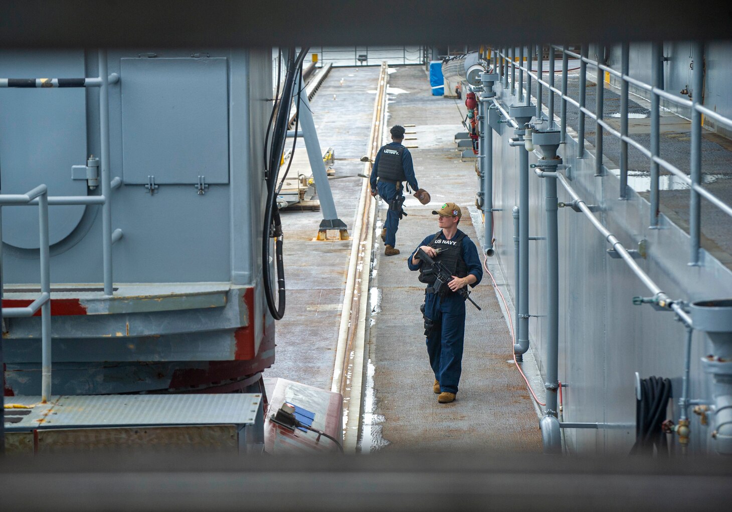 KOTA KINABALU, Malaysia (July 17, 2022) Logistics Specialist 2nd Class Cameron DeBenedet, from Atlanta, Georgia, assigned to the Emory S. Land-class submarine tender USS Frank Cable (AS 40), stands watch as the ship departs from Sepanggar Naval Base in Kota Kinabalu, Malaysia, July 17, 2022.  Frank Cable is currently on patrol conducting expeditionary maintenance and logistics in support of a free Indo-Pacific in the U.S. 7th Fleet area of operations. (U.S. Navy photo by Mass Communication Specialist 3rd Class Wendy Arauz)