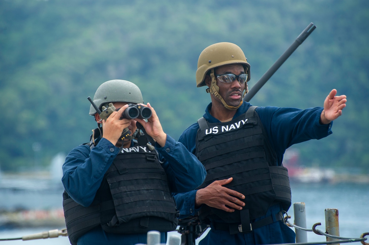 KOTA KINABALU, Malaysia (July 17, 2022) Gunner’s Mate 3rd Class Jonathan Marmolejo (left), from Los Angeles, and Torpedoman’s Mate 1st Class Mikal Magee (right), from Waycross, Georgia, both assigned to the Emory S. Land-class submarine tender USS Frank Cable (AS 40), stand watch as the ship departs from Sepanggar Naval Base in Kota Kinabalu, Malaysia, July 17, 2022. Frank Cable is currently on patrol conducting expeditionary maintenance and logistics in support of a free Indo-Pacific in the U.S. 7th Fleet area of operations. (U.S. Navy photo by Mass Communication Specialist 3rd Class Wendy Arauz)