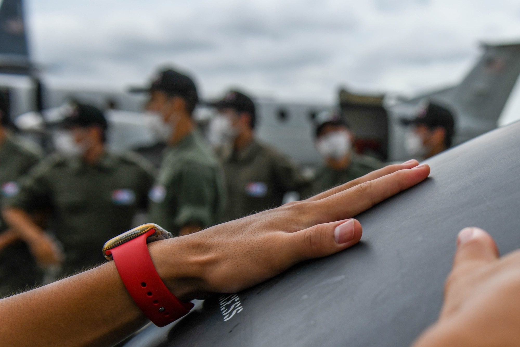 Hands touch the hood of a UH-1N Huey