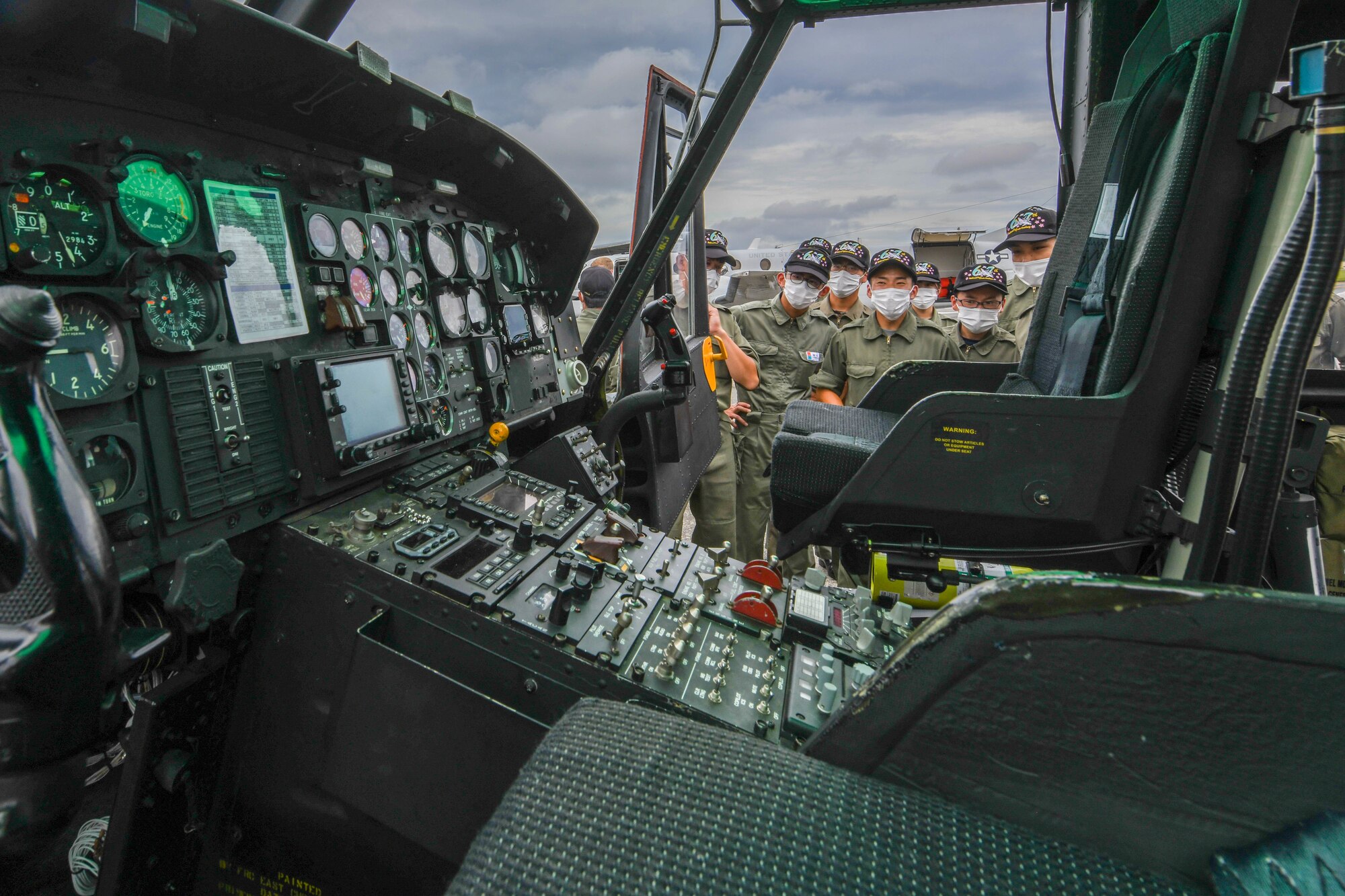 Cadets look inside of a UH-1N Huey