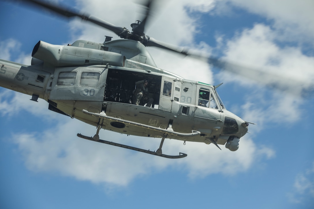 U.S. Marines with 3d Battalion, 2d Marines conduct aerial sniper drills from a UH-1Y Venom Venom assigned to Marine Light Attack Helicopter Squadron (HMLA) 469 on Camp Schwab, Okinawa, Japan, July 20, 2022. The training focuses on proficiency and lethality while engaging targets from an aircraft in flight. 3/2 is forward deployed in the Indo-Pacific under 4th Marines, 3d Marine Division as part of the Unit Deployment Program. (U.S. Marine Corps photo by Sgt. Kallahan Morris)