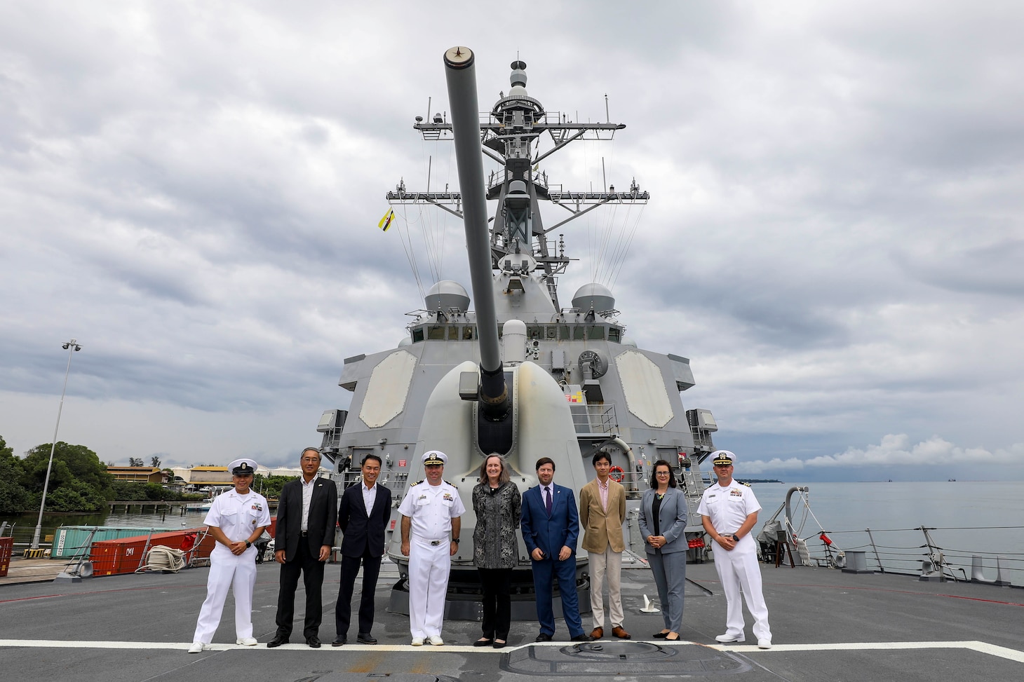 220725-N-HP061-0038 BRUNEI (July 25, 2022) Command Master Chief Alan Benavidez, Commanding Officer Cmdr. Joseph McGettigan, and Executive Officer Cameron Dennis, pose for a photo with a group of distinguished visitors on the fo’c’sle aboard Arleigh Burke-class guided-missile destroyer USS Higgins (DDG 76) as part of a ship tour during a scheduled port visit to Brunei, July 25. Higgins is assigned to Commander, Task Force 71/Destroyer Squadron (DESRON) 15, the Navy’s largest forward-deployed DESRON and the U.S. 7th Fleet’s principal surface force. (U.S. Navy photo by Mass Communication Specialist 1st Class Donavan K. Patubo)