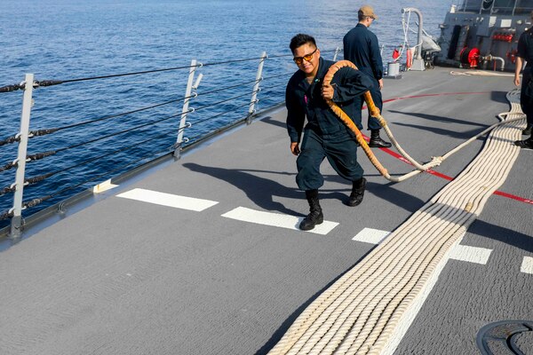 220722-N-HP061-0004 BRUNEI BAY, Brunei (July 22, 2022) Seaman Jordan Etsitty, from Fruitland, New Mexico, handles a mooring line on the foc’sle aboard Arleigh Burke-class guided-missile destroyer USS Higgins (DDG76). Higgins is assigned to Task Force 71/Destroyer Squadron (DESRON) 15, the Navy’s largest forward-deployed DESRON and the U.S. 7th fleet’s principal surface force. (U.S. Navy photo by Mass Communication Specialist 1st Class Donavan K. Patubo)