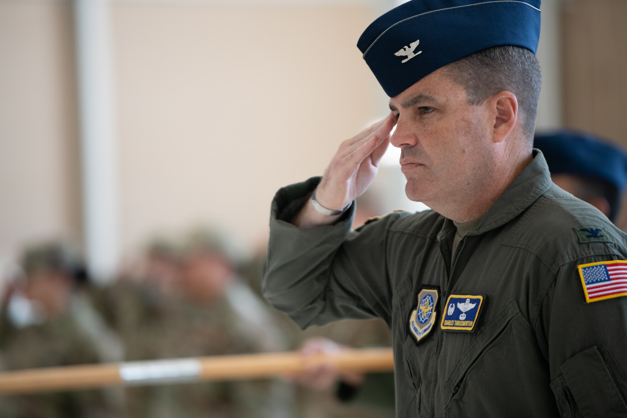 An Airman saluting while in formation.