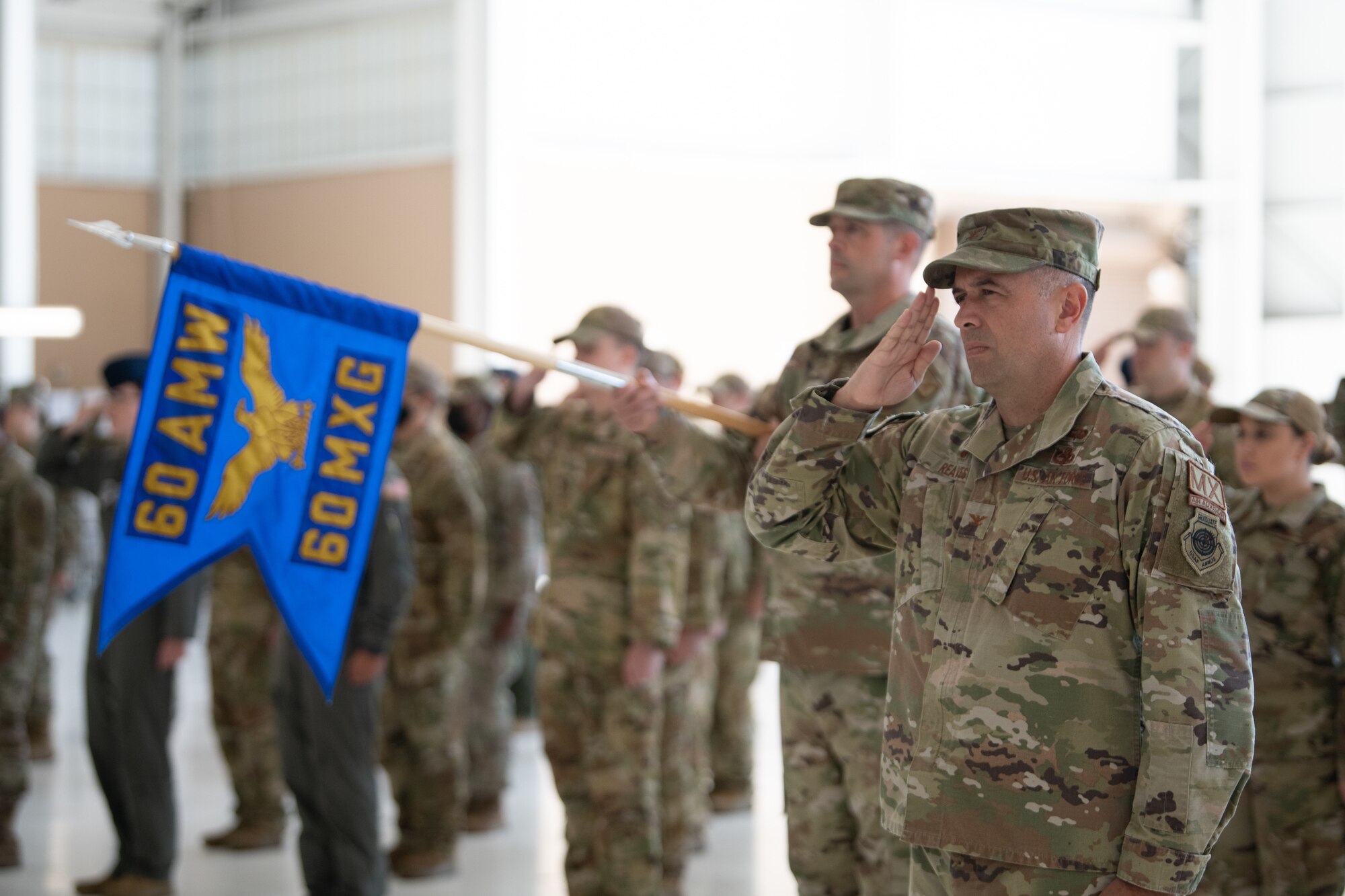 Airmen saluting in formation.