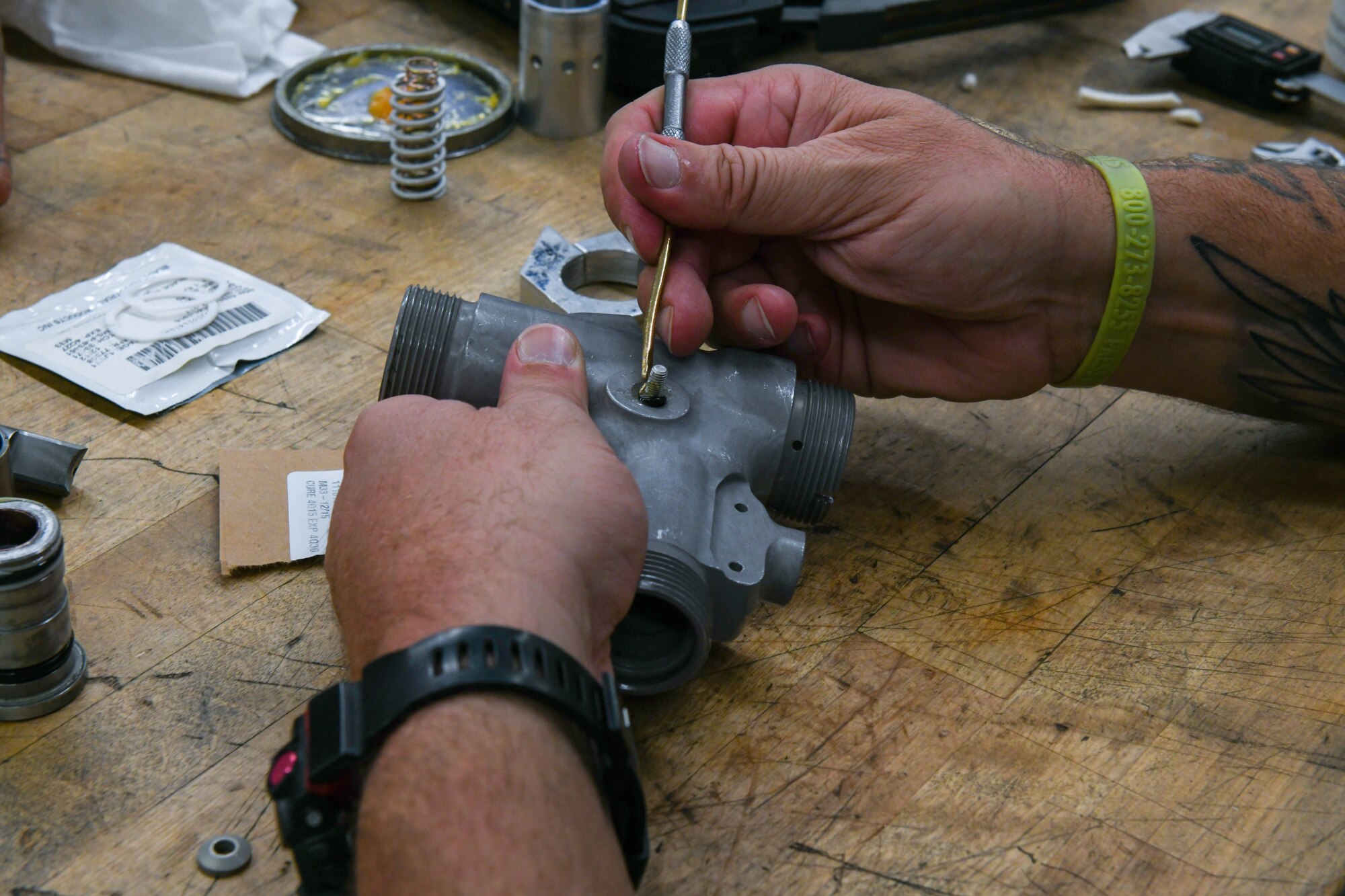 Tyson Salter, 97th Maintenance Squadron hydraulic mechanic, repairs a C-17 Globemaster III actuator at Altus Air Force Base (AAFB), Oklahoma, July 27, 2022. Actuators control a plane’s hydraulic components such as the landing gear, flight controls, cargo doors and booms. (U.S. Air Force photo by Airman 1st Class Miyah Gray)