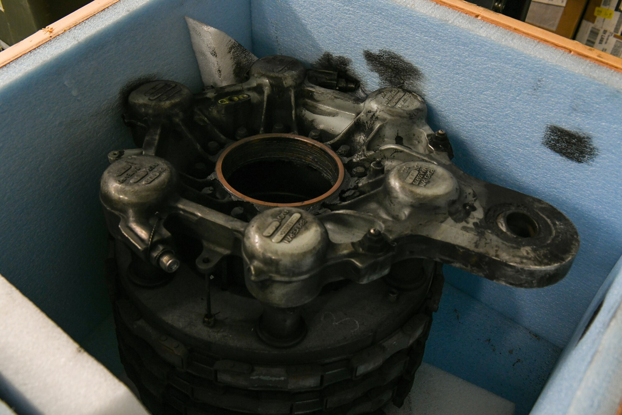 A C-17 Globemaster III landing-gear brake rests in a box at Altus Air Force Base, Oklahoma, July 27, 2022. Maintainers from the 97th Maintenance Squadron have repaired 43 landing gear breaks this year to help with plane part shortages. (U.S. Air Force photo by Airman 1st Class Miyah Gray)