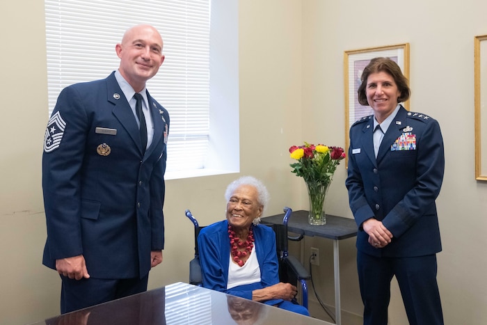 Chief Master Sgt. Stefan Blazier, Air University Command Chief Master Sergeant, and Lt. Gen. Andrea Tullos, Commander and President, Air University, pose with Congressional Gold Medal recipient Private Romay Catherine Johnson Davis at Montgomery City
