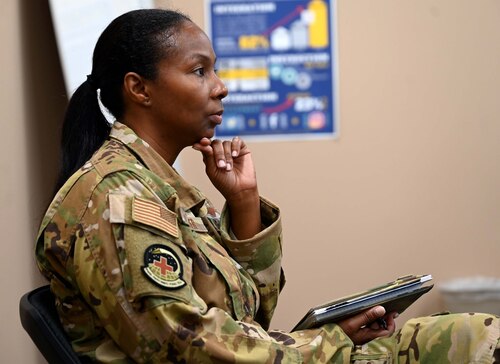 a woman listens to a speaker