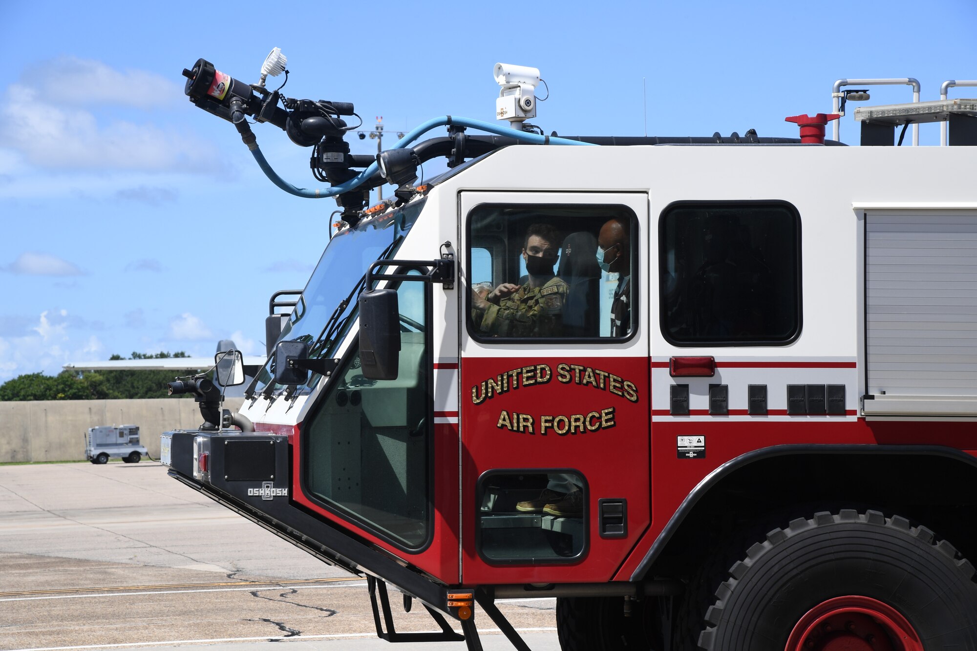 U.S. Air Force Senior Airman Tanis Jeffers, 81st Civil Engineer Squadron firefighter, provides a fire truck water spray demonstration during the Mississippi Educators Tour for Law and Public Safety and Fire Science tour at Keesler Air Force Base, Mississippi, July 27, 2022. More than 30 educators also received 81st SFS military working dog and virtual reality training demonstrations. (U.S. Air Force photo by Kemberly Groue)