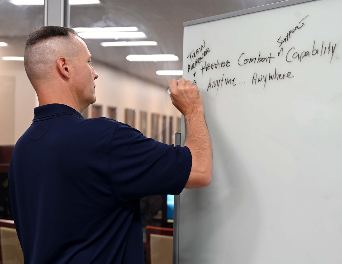 a man draws on a white board