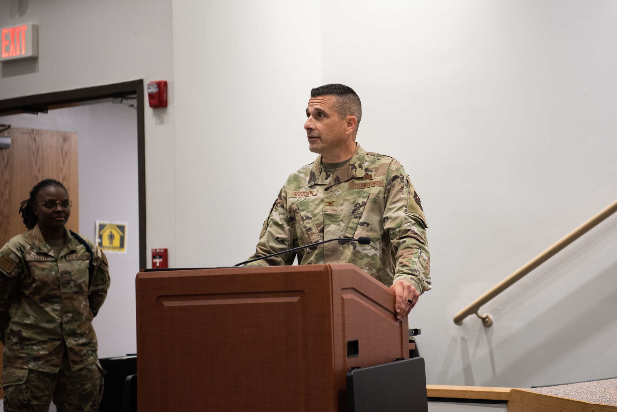 A man is standing at a podium addressing the audience
