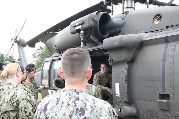 Staff Sgt. Nate Carey, a flight paramedic with 3rd General Support Aviation Battalion, 10th Combat Aviation Brigade, briefs reservists on how to load a litter for air medical evacuation during Operation Commanding Force, the annual Navy Reserve two-week training exercise, at Fort Drum. (Photo by Mike Strasser, Fort Drum Garrison Public Affairs) (Photo Credit: Michael Strasser)