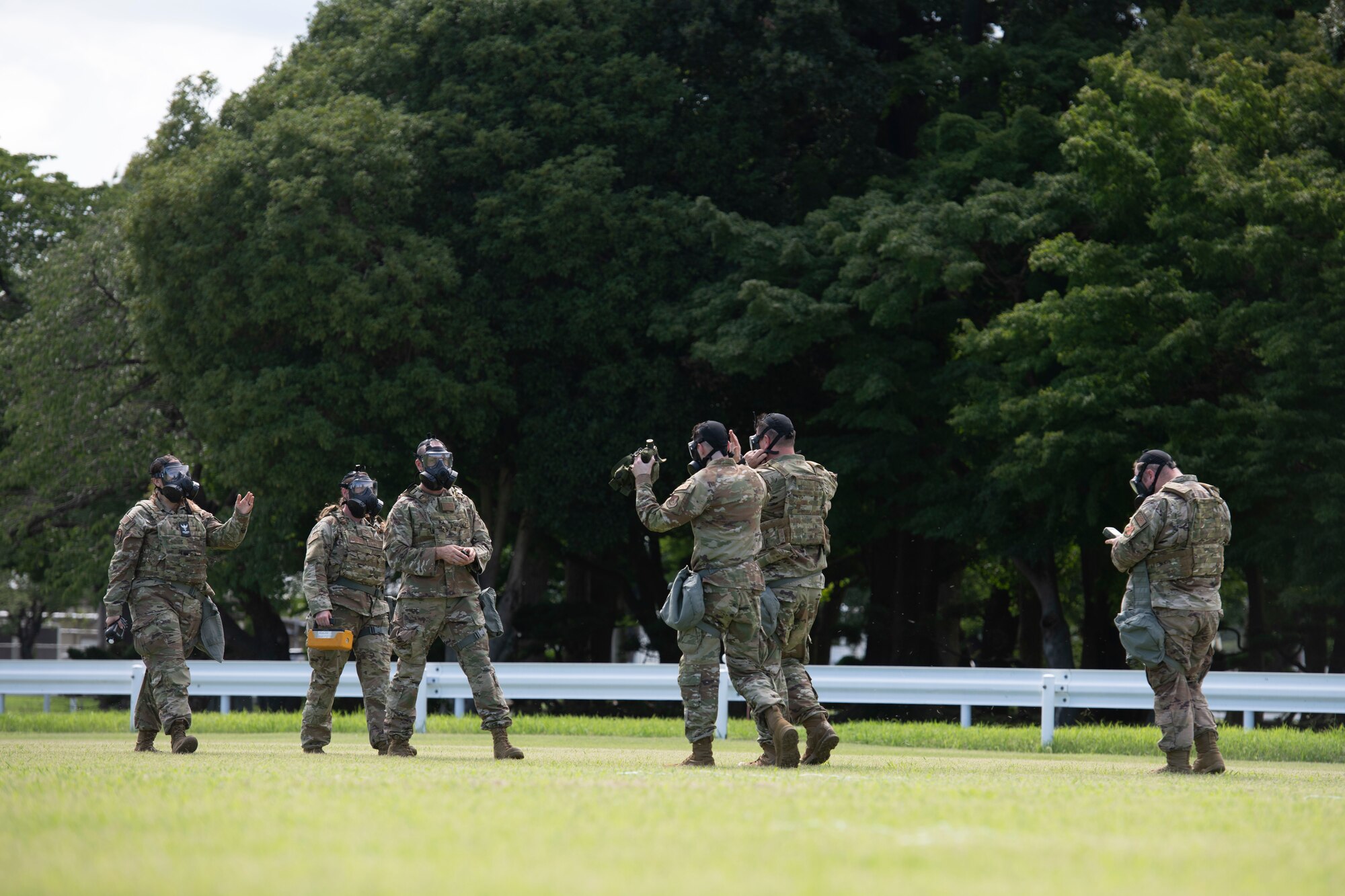 Members of the 374th Civil Engineer Squadron and 138th Civil Engineer Squadron from Tulsa Air National Guard Base, Oklahoma, rendezvous after perform a sweep of the area during a chemical, biological, radioactive and nuclear site survey training at the Sagami General Depot, Japan. This training allowed for the ANG to integrate with overseas active-duty members similar to what could be expected during a real-world deployment.  (U.S. Air Force photo by Tech. Sgt. Joshua Edwards)