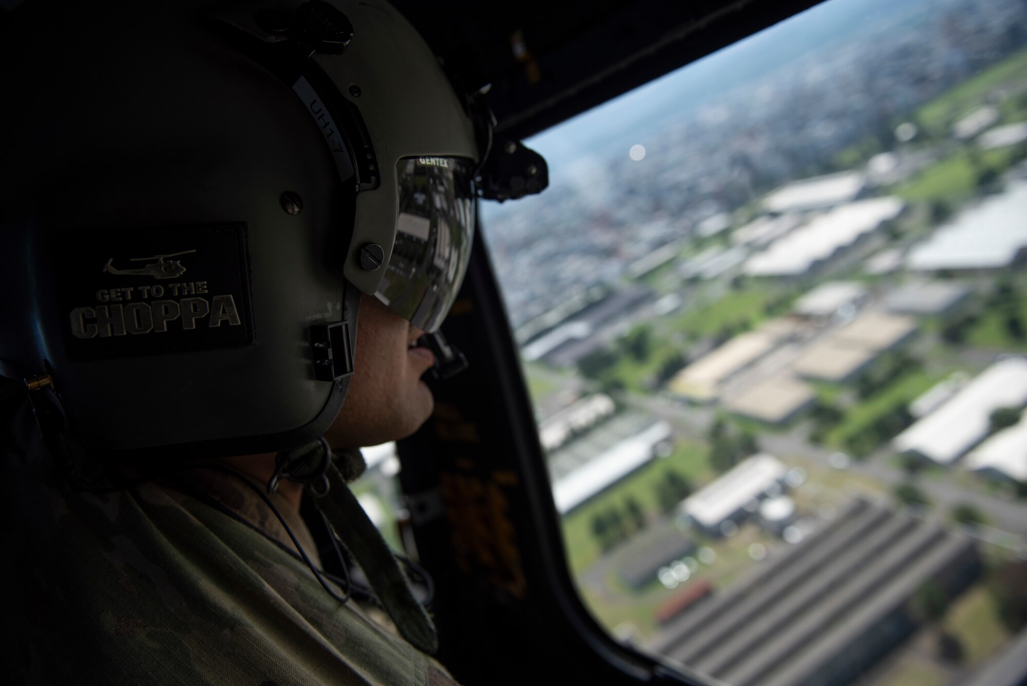 Senior Airman Kristian Castillo, 459th Airlift Squadron special missions aviation, surveys a landing zone at the Sagami General Depot, Japan. The 459th AS provided UH-1N Iroquois transportation support to assist two Air National Guard units for a chemical, biological, radioactive and nuclear site survey training. (U.S. Air Force photo by Tech. Sgt. Joshua Edwards)