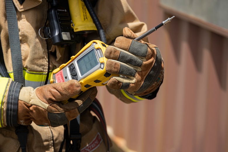 A firefighter with Marine Corps Installations Pacific Fire and Emergency Services utilizes a multi-reader to detect chemicals during a Hazardous Materials training exercise on Camp Hansen, Okinawa, Japan, June 27, 2022. The HAZMAT training included multiple simulated victims in a hazardous environment while neutralizing the contaminated area. MCIPAC F&ES is a regional fire department that operates eight fire stations across Japan and provides services to installations including fire suppression, technical rescue, hazardous materials, emergency medical, fire protection and prevention. (U.S. Marine Corps photo by Lance Cpl. Thomas Sheng)